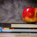 Education icon - text books and apple